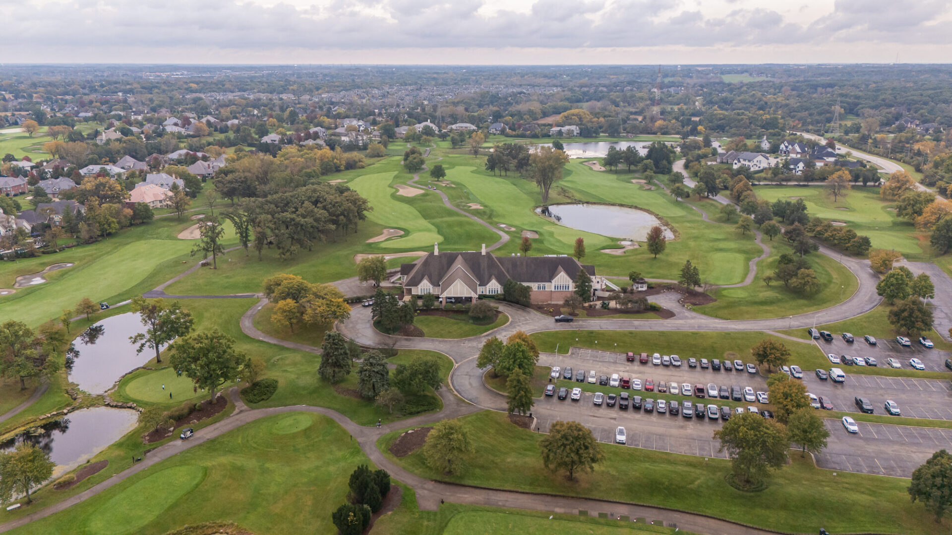 Aerial view of Ruffled Feathers Golf Club, with fairways, ponds and the clubhouse.